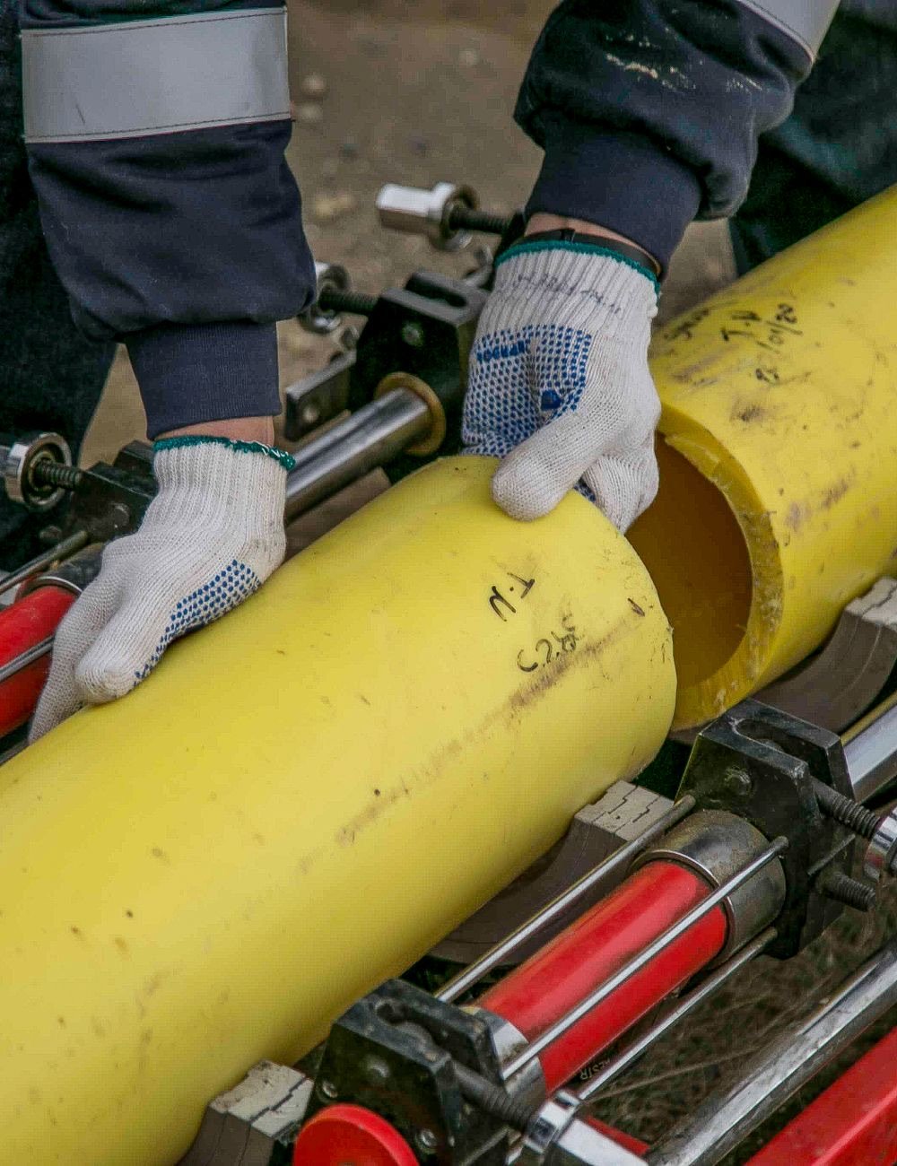 Drain technician fitting a new pipe run on site