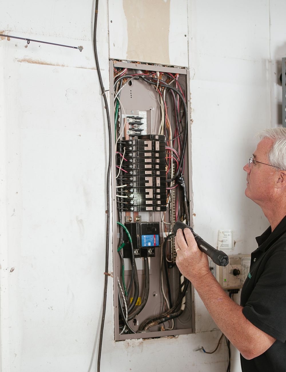 Electrician working inside a consumer unit