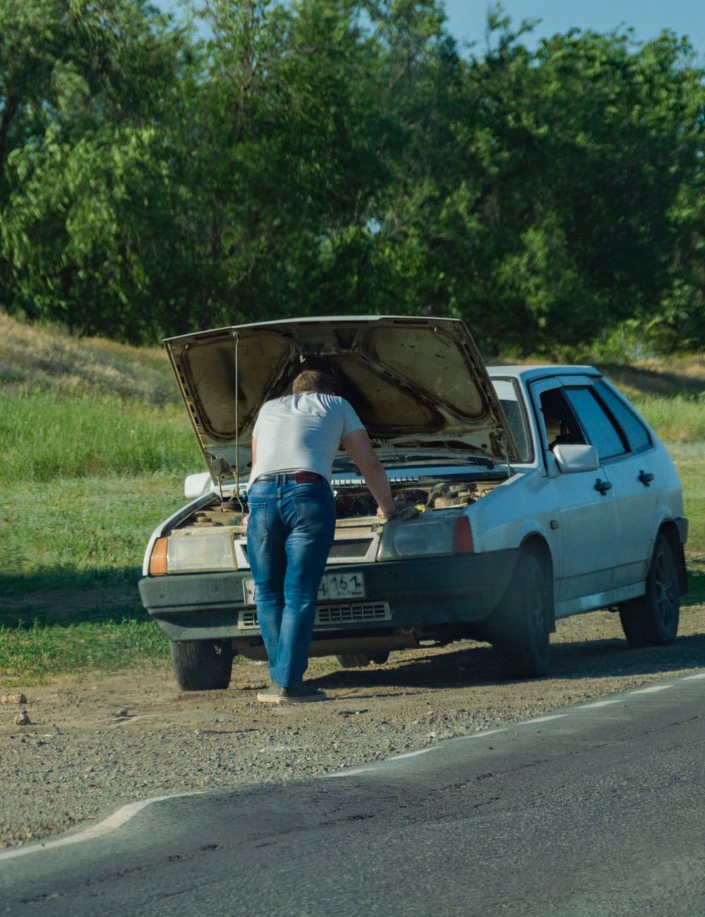 Tow truck operator loading a pickup onto a flatbed